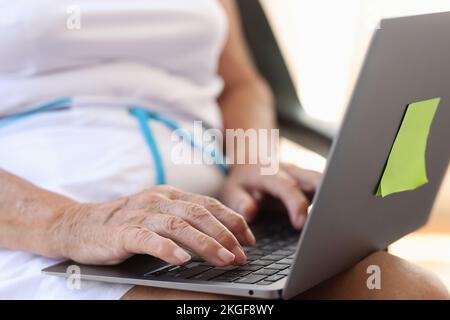 Old female hands typing on modern laptop Stock Photo