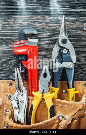 Tools for repairing in construction belt on wooden board. Stock Photo
