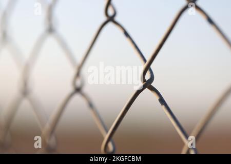 Metal chain links wire-mesh rabitz on blurred background Stock Photo