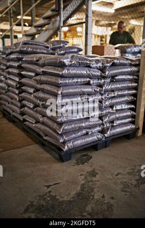 The world demands coffee and we supply. Bags of coffee beans in a warehouse. Stock Photo