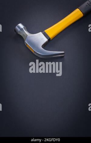 very close up view claw hammer with yellow and rubber handle on black background Stock Photo