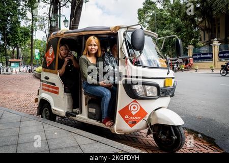 Phnom Penh, Cambodia. 23rd Nov, 2022. Cambodian tourists ride in a three-wheeled Tuk Tuk outside of Wat Phnom. Daily life in Phnom Penh, the capital city of the Kingdom of Cambodia, just days after world leaders convened in the city for the 2022 East Asia Summit. Credit: SOPA Images Limited/Alamy Live News Stock Photo