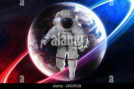 Astronaut on background of deep space planet in light of red and blue star Stock Photo