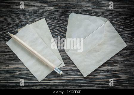 Vintage envelope paper sheet pencil on black board. Stock Photo