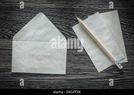 Vintage envelope paper pencil on black board. Stock Photo