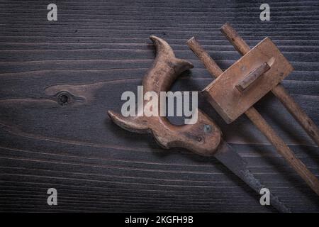 Vintage rusted hand saw wooden marking gauge on wood board. Stock Photo