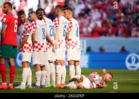 Croatia’s Marcelo Brozovic lies down behind a defensive wall to defend a free kick during the FIFA World Cup Group F match at the Al Bayt Stadium, Al Khor, Qatar. Picture date: Wednesday November 23, 2022. Stock Photo