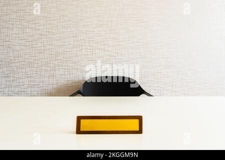 Empty name space on yellow office plate on white table with chair. Vector realistic mockup of wooden office white table with blank office plate,identi Stock Photo