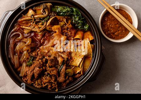 Spicy Hot Pot with Meat, Vegetables and Noodles Stock Photo