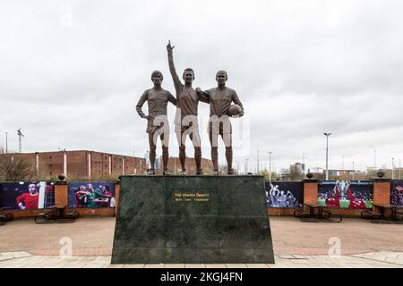 The United Trinity - George Best, Dennis Law, Bobby Charlton - Manchester United's Old Trafford stadium, Manchester Stock Photo