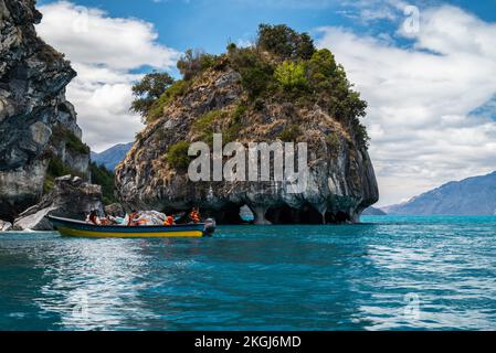 A group of tourists on a boat in General Carrera Lake by Marble Cathedral cliff Stock Photo