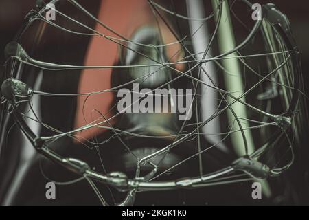 A closeup shot of glue stick strings on a glass with water droplets on a dark background Stock Photo