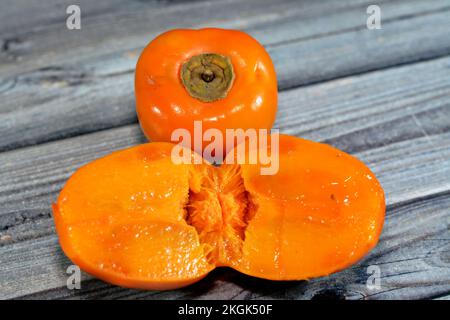 The persimmon is the edible fruit of a number of species of trees in