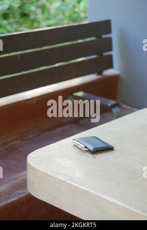 left wallet on a bench in the park Stock Photo - Alamy