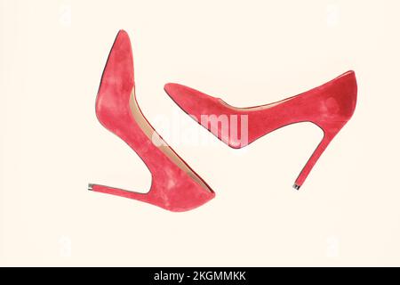 Luxury footwear concept. Footwear with thin high heels, stiletto shoes, top view. Shoes made out of red suede on white background, isolated. Pair of Stock Photo