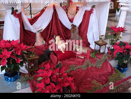 Nativity scene with baby Jesus. Elements of the Catholic Christian crib. Decor in the church.  Stock Photo