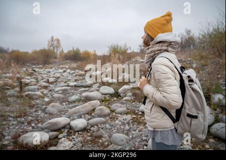 Slow and not deep mountain river with rounded stones Stock Photo