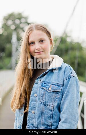 Portrait of teenage girl on a bridge Stock Photo