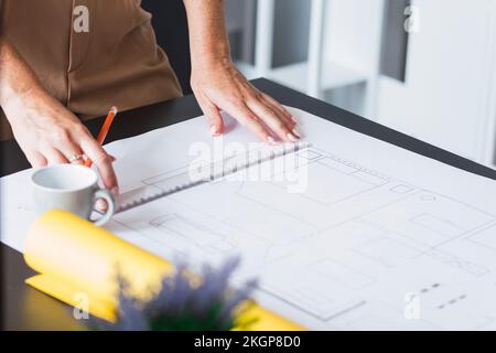 Hands of architect working on blueprint in office Stock Photo