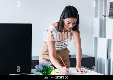 Architect working on blueprint in office Stock Photo