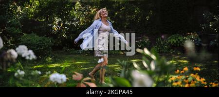 Happy mature woman enjoying in garden Stock Photo