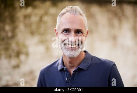 Smiling mature man with beard and gray hair Stock Photo