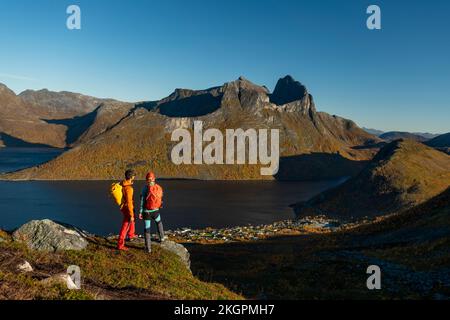 Mature couple standing on top of mountain admiring view Stock Photo