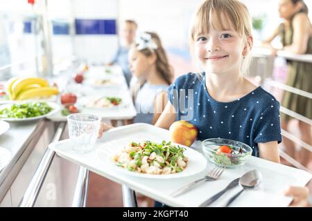 Smiling Children Holding Food Tray In Canteen At School Stock Photo,  Picture and Royalty Free Image. Image 119274036.