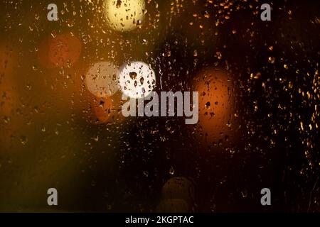 Water on glass. Raindrops on window. Background window. Evening light outside window. Stock Photo