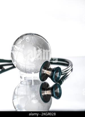 Studio shot of stethoscope pointed at glass globe Stock Photo