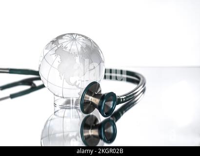 Studio shot of stethoscope pointed at glass globe Stock Photo