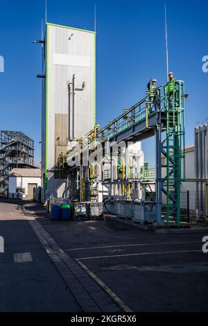 Engineers standing on bridge at recycling plant Stock Photo