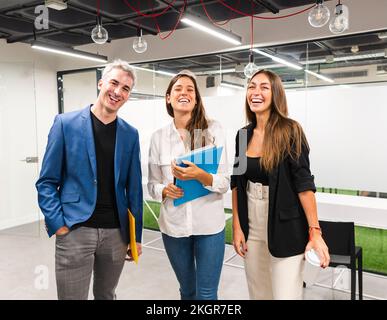 Business colleagues laughing in office Stock Photo