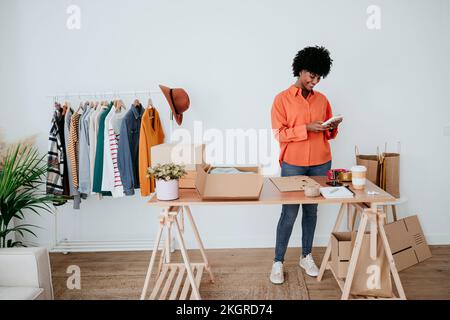 Happy businesswoman using smart phone at home office Stock Photo
