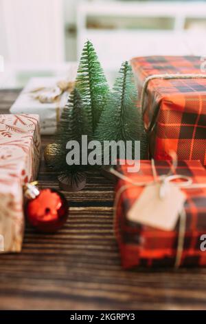 Christmas tree amidst gifts on table Stock Photo