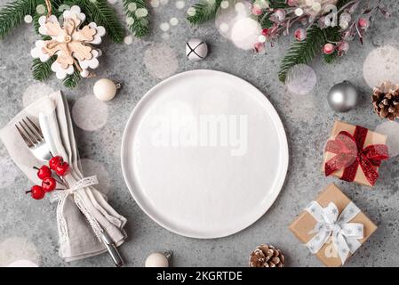 Christmas place setting on gray table. Stock Photo