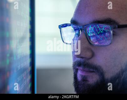 Trader analyzing stock market data on computer screen Stock Photo