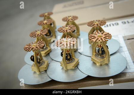 Close up of automatic fire sprinkler nozzles waiting to be fitted in a UK distribution centre. Stock Photo
