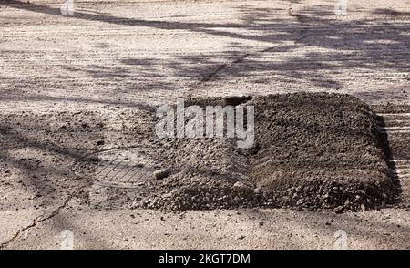 asphalt deposited on the road for pavement repair Stock Photo