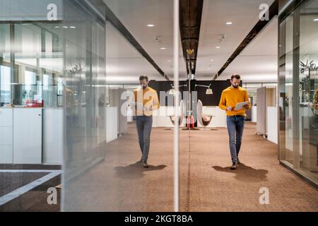Young businessman using tablet PC in office Stock Photo