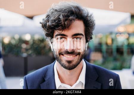 Smiling handsome businessman with hair stubble Stock Photo