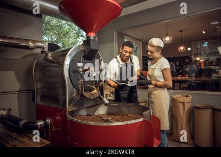 Two coffee company workers involved in work Stock Photo