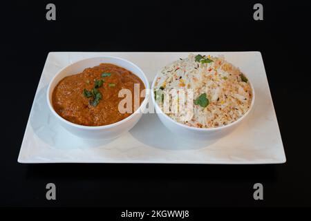 Indian dishe culinary Still Life. Chicken Madras served with rice on a plate Stock Photo