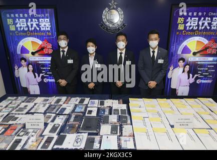 (L to R) Lau Kai-yin, Senior Inspector, Regional Crime Unit, Kowloon East Regional Headquarters; Hui Nok, Chief Inspector of Regional Crime Unit, Kowloon East Regional Headquarters; Wong Yick-lung, Superintendent (Operations), Crime Kowloon East Regional Headquarters; Tang Kwok-hin, Chief Inspector, Cyber Security and Technology Crime Bureau; pose in front of the seized mobile phones displayed in the press conference of a joint enforcement action with Macao Judiciary Police combating online employment fraud, at Police Headquarters. 16NOV22. SCMP/ Dickson Lee Stock Photo