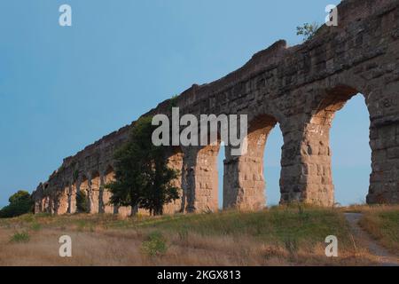 Ancient aqueducts at Parco Degli Acquedotti. Stone arches built to carry water into the city during the Roman Empire. Outdoor park in Rome, Italy. Stock Photo