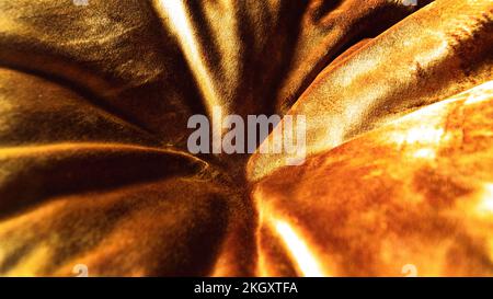 Close-up of fabric texture. Gold color background Yellow abstract patterns on the fabric surface. Softness concept idea background. Stock Photo