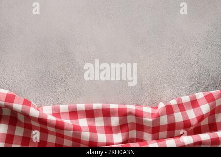 Kitchen gray table top with red checkered towel. Top view. Flat lay. Space for your design, recipe or menu. Stock Photo