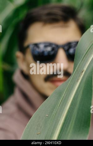 Large male portrait. A man in dark glasses with a mustache and beard. Stock Photo