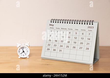 May 2023 calendar and small vintage clock on the desk Stock Photo