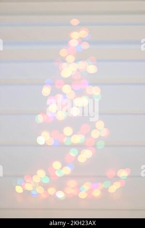 Christmas and New Year ,blur background. Lots of lights glowing .Colorful Bokeh silhouette of Christmas tree.defocused lights Stock Photo
